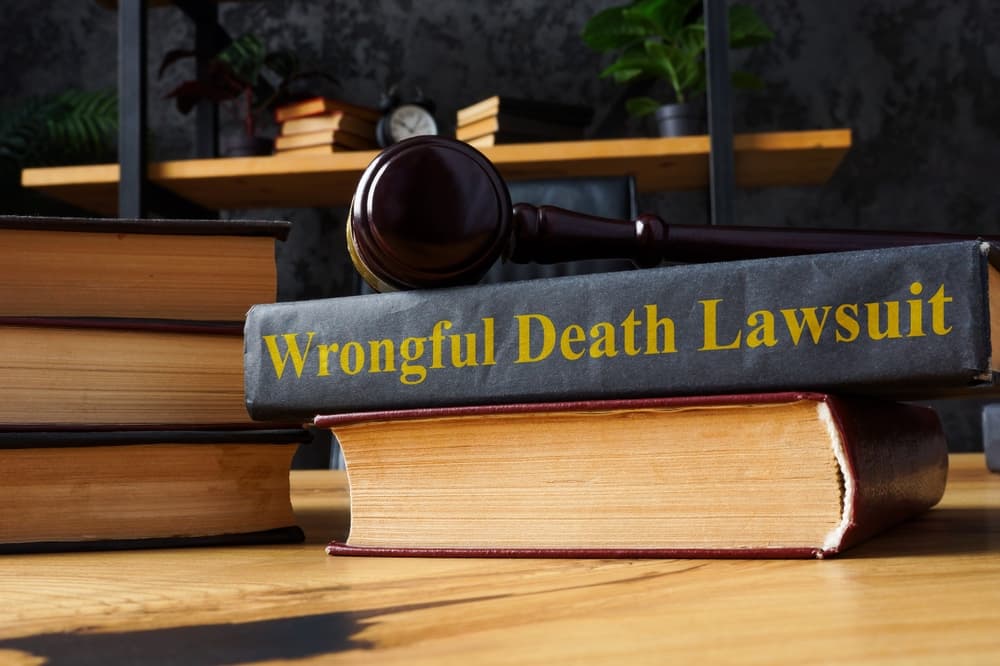 Who Can File a Wrongful Death Suit. Pile of books and Wrongful death lawsuit.