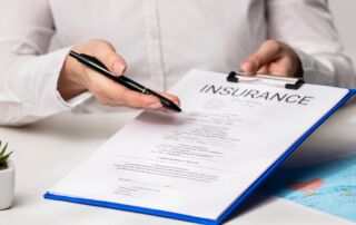 Person reviewing an insurance form, representing the claim process after an accident.