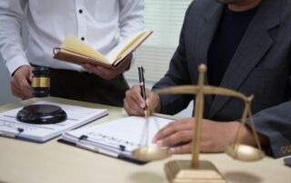 Personal injury lawyer reviewing documents and calculating the value of a client’s claim.