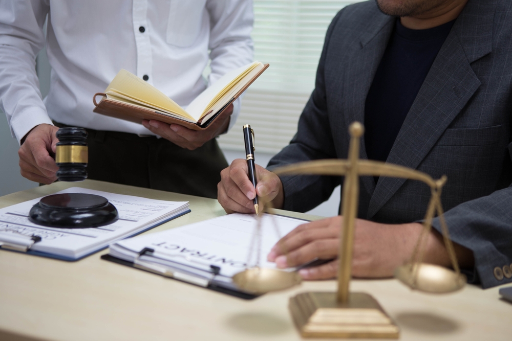 Personal injury lawyer reviewing documents and calculating the value of a client’s claim.