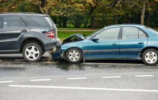 Rear-end car accident showing severe vehicle damage that may lead to an insurance claim or settlement dispute