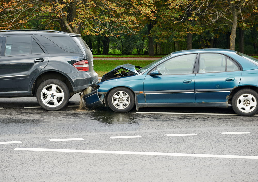 Rear-end car accident showing severe vehicle damage that may lead to an insurance claim or settlement dispute
